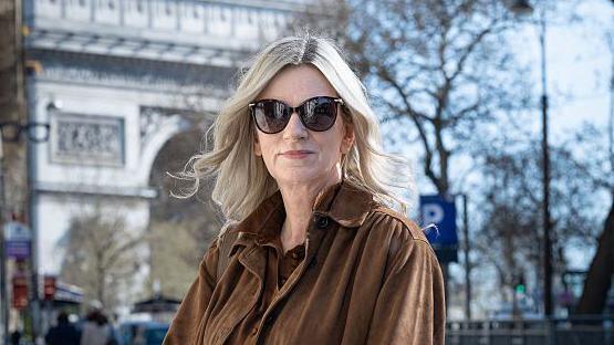 Lisa Brinkworth standing in front of a white wall