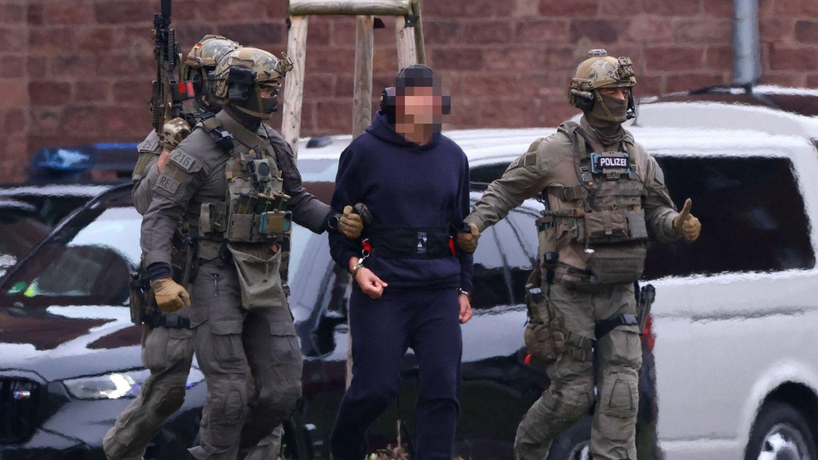 Serhii K flanked by armed police