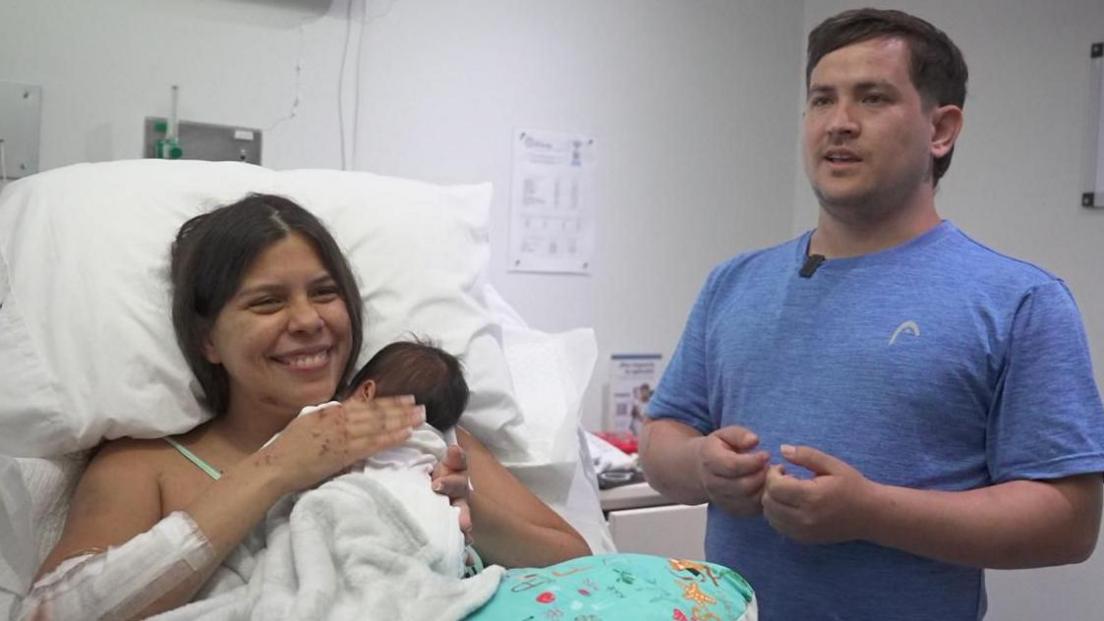 Dayana Patino holding newborn Juan David in hospital