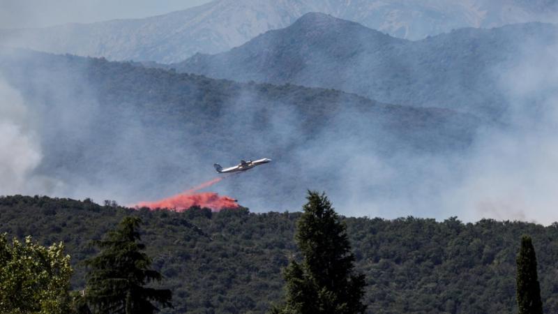 Firefighting plane drops retardant over wildfire near Perpignan