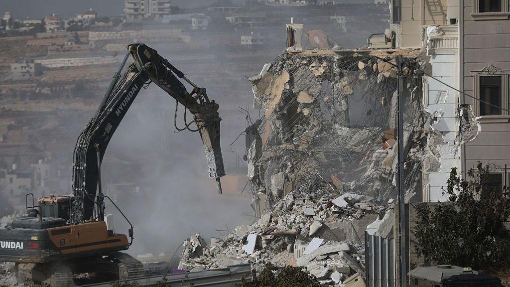 army diggers demolishing a Palestinian home