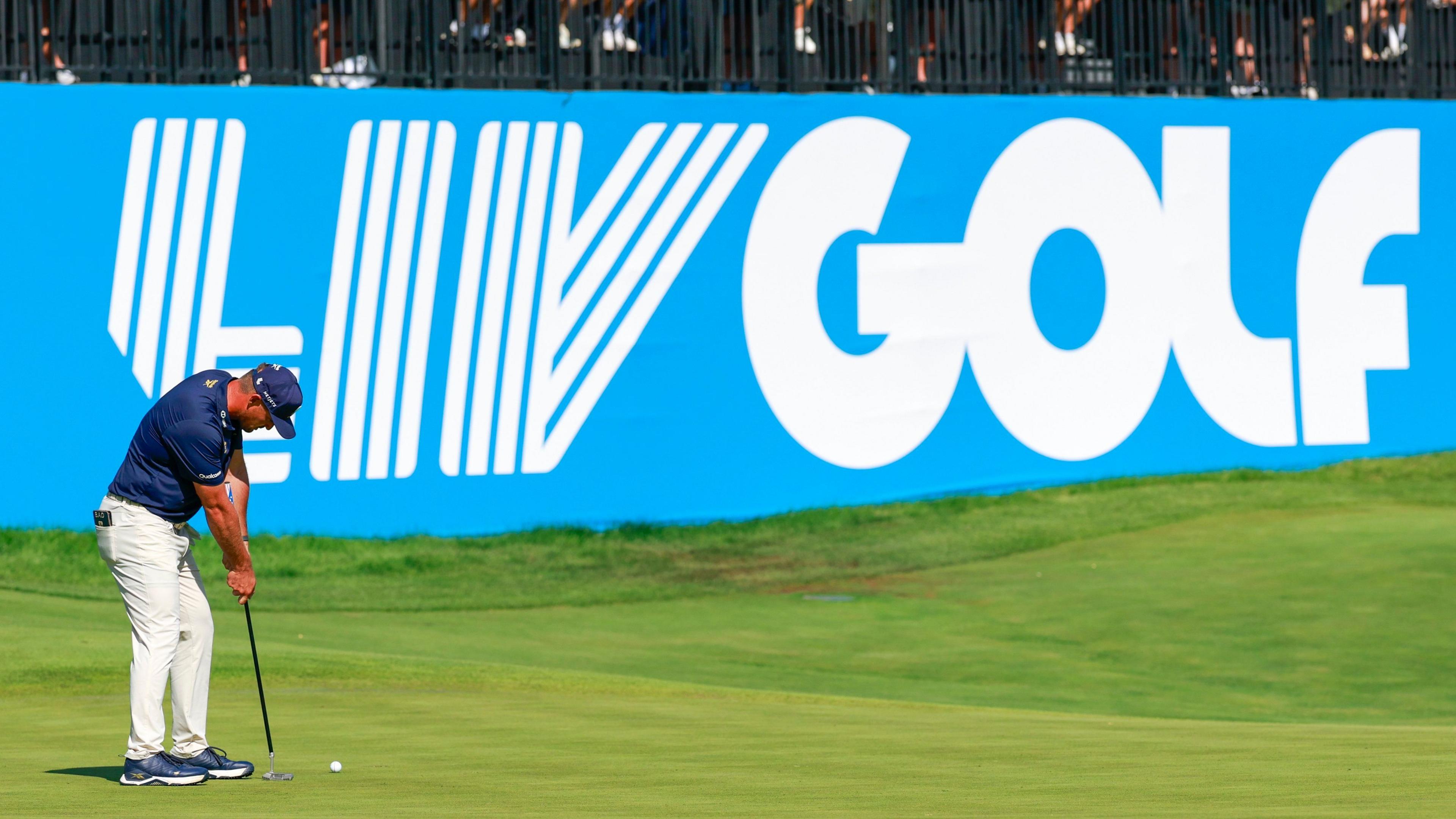 Bryson DeChambeau, a LIV Golf player, in front of a LIV Golf sign