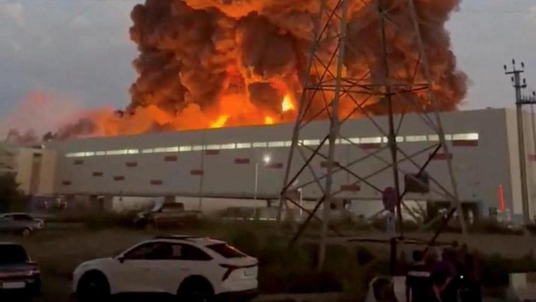 Smoke rises from a Wildberries warehouse on fire after an attack in Nevinnomyssk, Russia