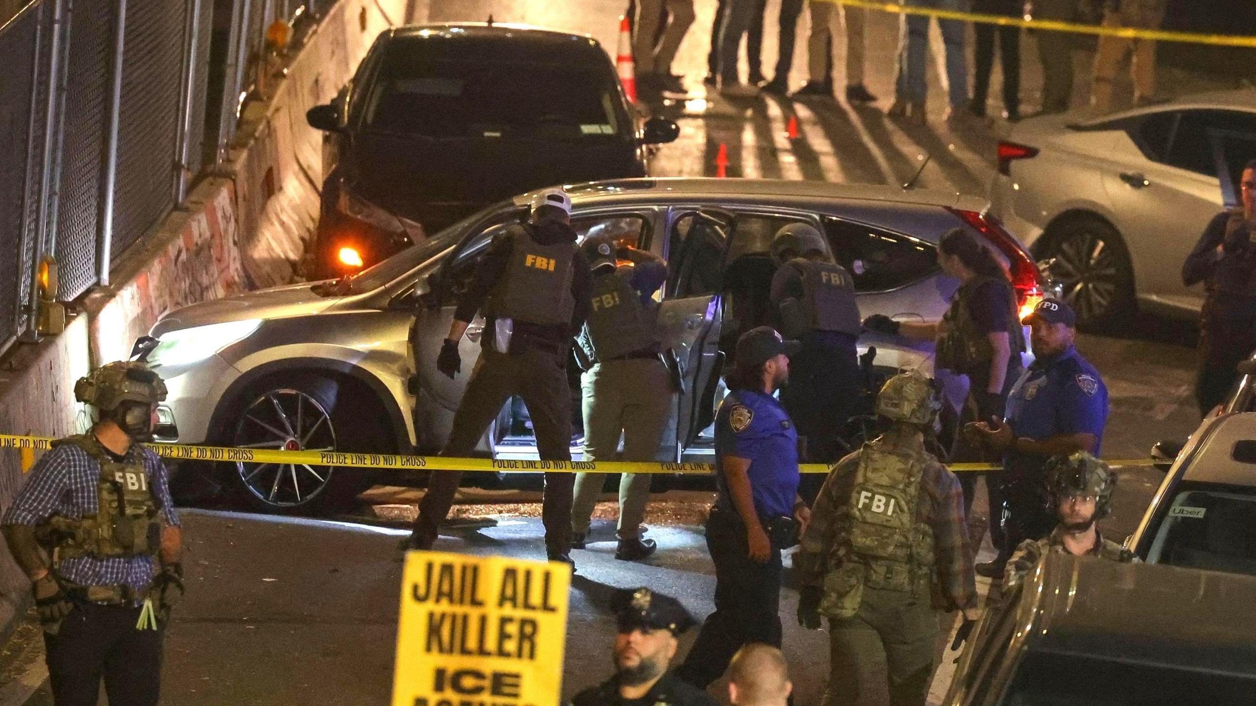 Officers searching a car at the scene