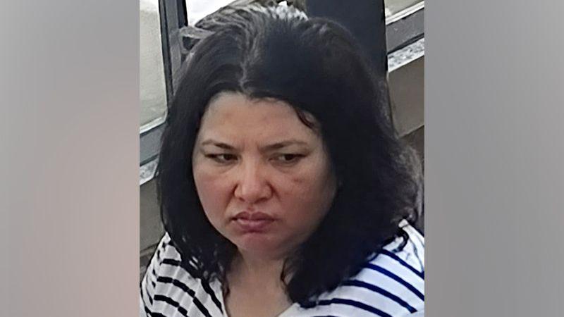 Woman with dark hair in a striped black and white shirt